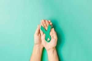 September Ovarian cancer Awareness month, Woman holding teal Ribbon color for supporting people living, and illness. Healthcare and world cancer day concepts photo