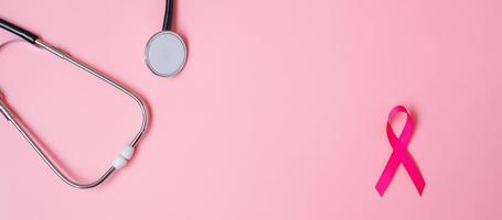 Breast Cancer Awareness, Pink Ribbon with Stethoscope on pink background for supporting people living and illness. Woman Healthcare and World cancer day concept photo