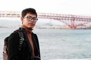 Happy man in coat and camera, Asian traveler enjoy and sightseeing view in the ship photo