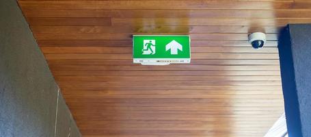 Fire Emergency exit sign on the wall background inside building. Safety concept photo