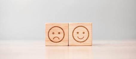 emotion face symbol on wooden blocks. Service rating, ranking, customer review, satisfaction, evaluation and feedback concept photo