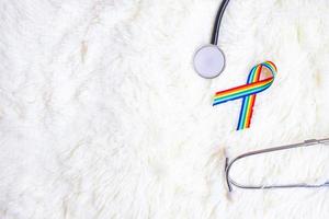 LGBTQ Rainbow ribbon with stethoscope on white background. Support Lesbian, Gay, Bisexual, Transgender, Queer community and Rights concept photo