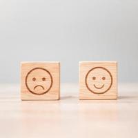 emotion face symbol on wooden blocks. Service rating, ranking, customer review, satisfaction, evaluation and feedback concept photo