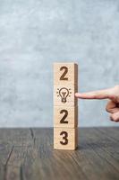 2023 block with lightbulb icon. Business Idea, Creative, Thinking, brainstorm, Goal, Resolution, strategy, plan, Action, change and New Year start concepts photo