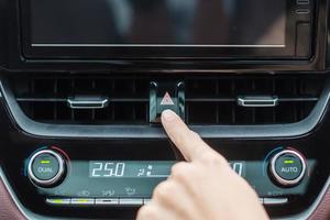 Finger presses the emergency stop button inside the car. Safety and transportation concept photo