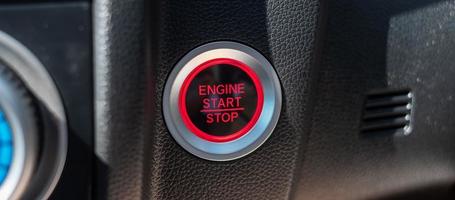 a car ignition button or START engine inside modern electric automobile. Keyless, change, strategy, vision, innovation and future concept photo