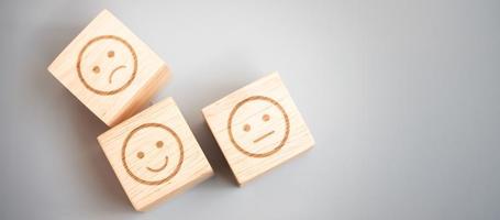 emotion face symbol on wooden blocks. Service rating, ranking, customer review, satisfaction, evaluation and feedback concept photo