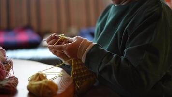 Image of a woman knitting video