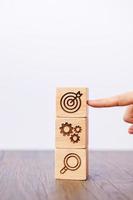 wood block with business goal, strategy, target, mission, action, objective, teamwork, brainstorm and idea concept photo