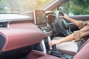 woman driver stick shift transmission a car gear, hand controlling steering wheel during vehicle moving. Journey, trip and safety Transportation concepts photo