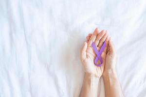 Pancreatic Cancer, testicular, world Alzheimer, epilepsy, lupus and violence day Awareness month, Woman holding purple Ribbon for supporting people living. Healthcare and World cancer day concept photo