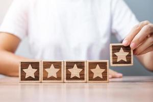 Man hand holding Star block. Customer choose rating for user reviews. Service rating, ranking, customer review, satisfaction, evaluation and feedback concept photo