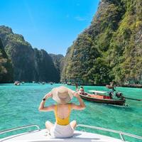 Woman tourist on boat trip, happy traveller relaxing at Pileh lagoon on Phi Phi island, Krabi, Thailand. Exotic landmark, destination Southeast Asia Travel, vacation and holiday concept photo