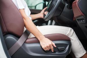 Hand adjust car seat before drive on the road . Ergonomic and safety transportation concept photo