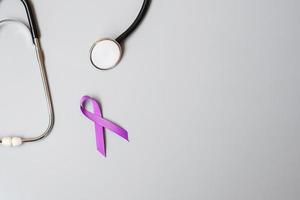 Pancreatic Cancer, world Alzheimer, epilepsy, lupus and domestic violence day Awareness month, Woman holding purple Ribbon with stethoscope. Healthcare and World cancer day concept photo