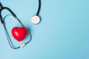 Top view Stethoscope with Red heart shape on blue background with copy space for text. Healthcare, life Insurance, Health day, World Heart Day and Happy Doctor day concept photo