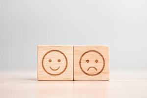 emotion face symbol on wooden blocks. Service rating, ranking, customer review, satisfaction, evaluation and feedback concept photo