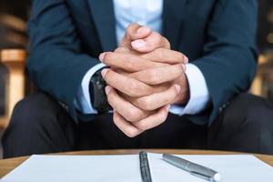 Businessman in suit at office or cafe, hand of man holding during something thinking. business, decision and vision concepts photo