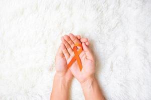 Leukemia, Kidney cancer day, world Multiple Sclerosis, CRPS, Self Injury Awareness month, Orange Ribbon for supporting people living and illness. Healthcare and World cancer day concept photo