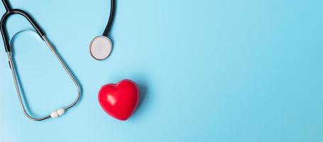 Top view Stethoscope with Red heart shape on blue background with copy space for text. Healthcare, life Insurance, Health day, World Heart Day and Happy Doctor day concept photo