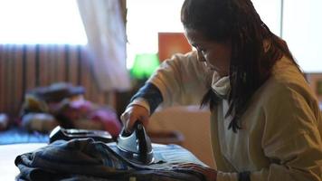 Image of a woman ironing
