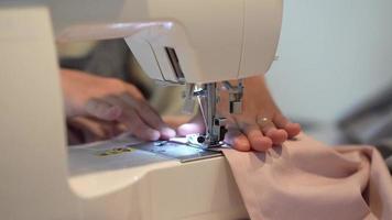 Woman using a sewing machine video