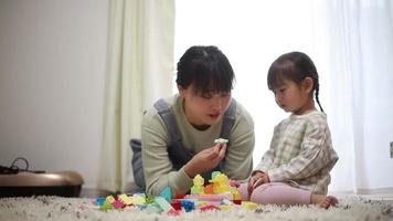 Parents and children playing with blocks video