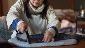 Image of a woman ironing