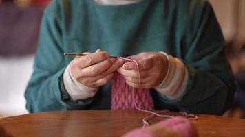 Image of a woman knitting video