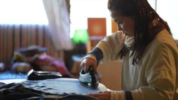 Image of a woman ironing video