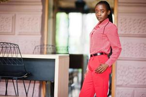 Pretty braids business african american lady bright bossy person friendly wear office red shirt and trousers. photo