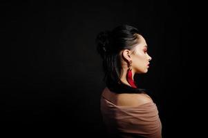 Studio portrait of back hairdress brunette girl on black background. photo