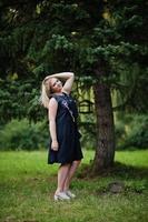 Portrait of gorgeous girl wear on black at hen party, posed at park. photo