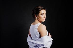 Studio portrait of brunette girl with make up on black background. photo