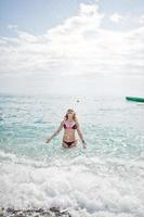 Beautiful model relaxing on a beach dressed in a swimsuit. photo