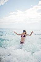 Beautiful model relaxing on a beach dressed in a swimsuit. photo