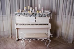 Old piano with new year decorations, candles. photo