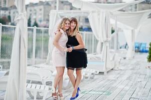 Two girls posed at hen party on the pier of beach. photo