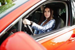 Gorgeous woman sitting inside car interior. photo