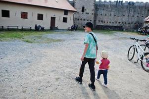 Brother with little sister walking at Veveri castle, Czech Republic. photo