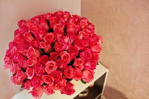 Large bouquet of pink roses in the room. photo