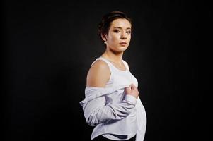 Studio portrait of brunette girl with make up on black background. photo