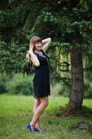 Portrait of gorgeous girl wear on black at hen party, posed at park. photo