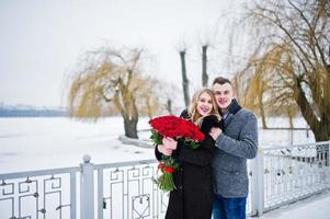 Married proposal with 101 rose at winter day. Loving couple.
