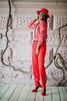 Pretty braids business african american lady bright bossy person friendly wear office red shirt, hat and trousers. photo