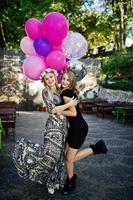 Two girls wear on black with balloons at hen party. photo