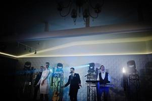 Musicial music live band performing on a stage with different lights. photo