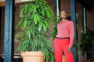 Pretty braids business african american lady bright bossy person friendly wear office red shirt and trousers. photo