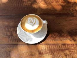 Hot coffee cup on table photo