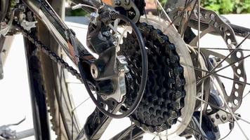 the guy repairs the bike in the summer hot weather. Bicycle chain, wheel, spokes video